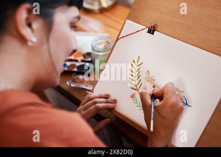 Woman, house and artist painting with color for design with closeup, passion and paintbrush. Painter, drawing and flowers for creativity in home Stock Photo