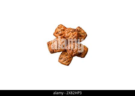 Triangular puffs with feta cheese, tomatoes with salt, spices and herbs on a dark concrete background Stock Photo