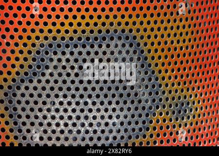 an abstract of a multi-colored metal background with circles holes Stock Photo