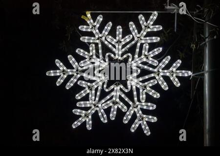 Shiny snowflake on black background with abstract pattern Stock Photo