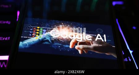 Viersen, Germany - May 9. 2024: Closeup of smartphone with logo lettering of Google AI artificial intelligence  on computer keyboard Stock Photo
