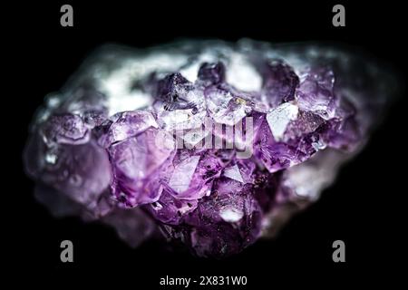 Macro details of an amethyst rock isolated on black background Stock Photo