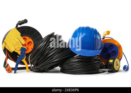 Rolled cables, hardhat, wire stripper and extension cable reels on white background Stock Photo