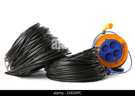 Rolled cables and extension cable reel on white background Stock Photo