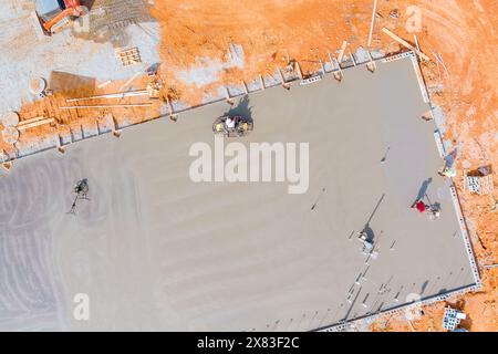 Foundation was poured with concrete workers polished concrete using concrete polishing machines. Stock Photo