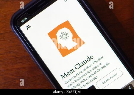 Claude website seen in an iPhone screen. Claude AI is a chatbot by Anthropic that engages in natural conversations and assists with tasks. Stock Photo