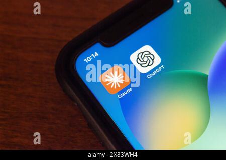 Vancouver, CANADA - May 20 2024 : Claude by Anthropic and ChatGPT (OpenAI) app icons seen in an iPhone screen. Stock Photo