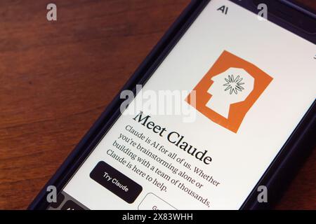 Claude website seen in an iPhone screen. Claude AI is a chatbot by Anthropic that engages in natural conversations and assists with tasks. Stock Photo