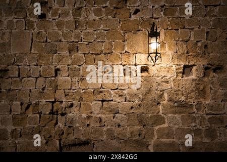 Dark brick wall background with an old lantern. Stock Photo