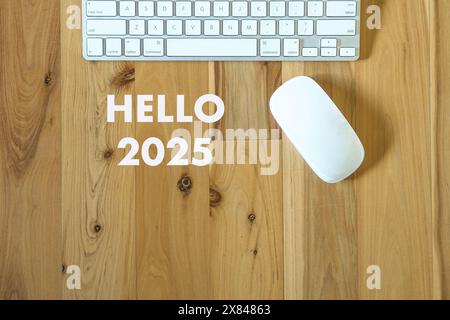 Hellow 2025, text next to computer keyboard and mouse. Top view. Stock Photo