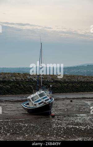 Small boats moored in the harbour at Rhos-on-Sea, Wales, Uk at low tide. Stock Photo
