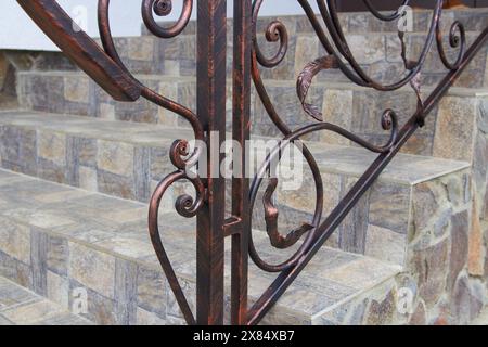 metal forged handrails with a frame on a ceramic tile Stock Photo