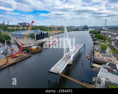 Aerial view from drone of new Govan-Partick Bridge under construction across the River Clyde at the Riverside Museum. The new swing bridge will connec Stock Photo