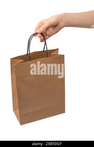 Paper bag in woman hand isolated on a white background. Shopping cocnept. Stock Photo