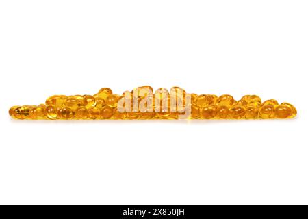 A group of yellow capsules isolated on a white background. Stock Photo
