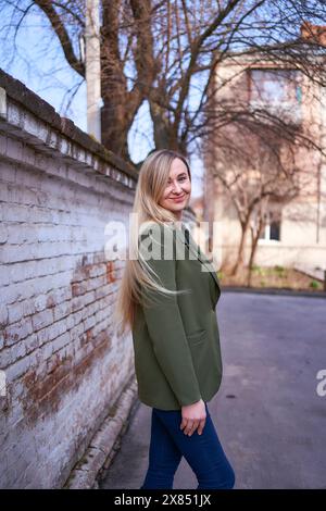 stylish woman with long blond hair on a spring day Stock Photo