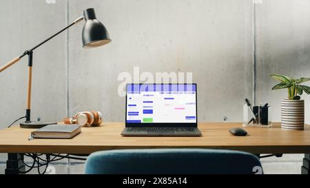 Laptop Computer with Software Platform Screen Display Standing on a Desk. Efficiently Minimalistic Design of Modern Office Space. Business, Scheduling, Website for Time Management and Planning Stock Photo