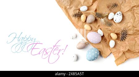Easter eggs and feathers on a brown kraft paper background on a white table. Top view. For easter greeting cards with copy space. Stock Photo