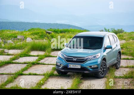 mnt. runa, ukraine - jun 22, 2019: honda crv on a paved platform in mountains. 4 generation of a popular family SUV, restyling model 2015 in cyan blue Stock Photo