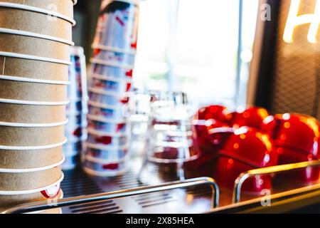 Paper disposable cups, glass cups and ceramic coffee cups, clean on the counter in a cafe. copy space. Selected focus. Stock Photo