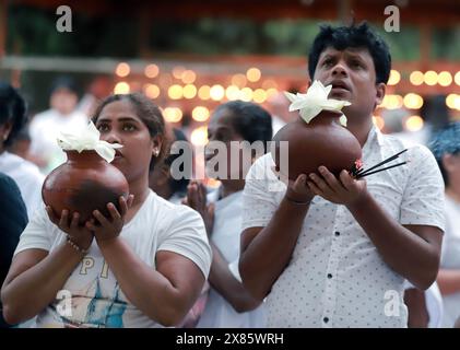 Colombo, Sri Lanka. 23rd May, 2024. People take part in a religious observance of the Vesak Festival at a temple in Colombo, Sri Lanka, May 23, 2024. The Vesak Festival is one of the holiest festivals celebrated in Sri Lanka as it marks the birth, enlightenment and demise of Lord Buddha. Credit: Ajith Perera/Xinhua/Alamy Live News Stock Photo