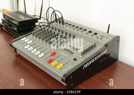 High fidelity audio mixing console with multiple knobs and sliders in a recording studio. Perfect for music production, sound engineering, and broadca Stock Photo