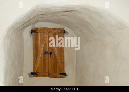 Rustic Wooden Door Against Textured Cave-Like Wall Stock Photo