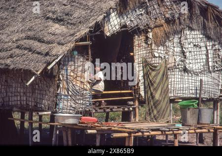 Philippines, Manila; Little boy in door opeming of the house on poles in the slum he lives in. Stock Photo