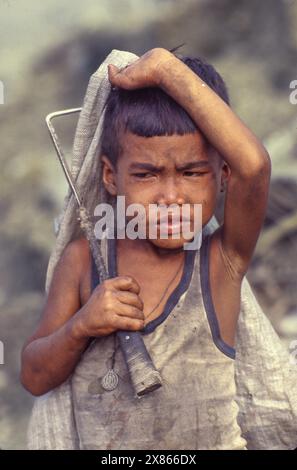 Philippines, Manila; Boy collects plastic and glass on the 'Smokey Mountain' garbage dump. Stock Photo