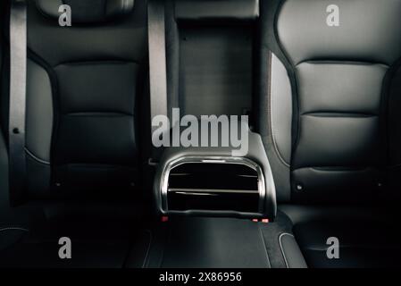 Back passenger seats with armrest electric car. Rear passenger seats. Stock Photo