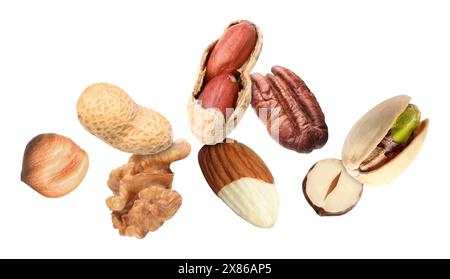 Many different nuts in air on white background Stock Photo