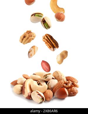 Mix of different nuts falling on white background Stock Photo