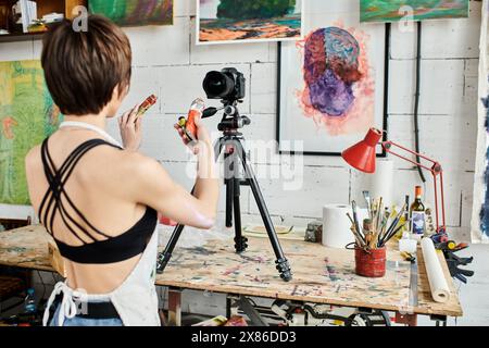 A woman teaching how to paint on camera. Stock Photo