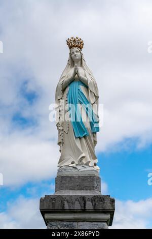 Lourdes, France - 17 April, 2024: view of the Our Lady of Lourdes statue in front of the sanctuary Stock Photo