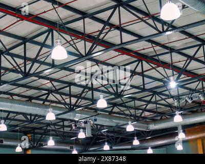 industrial ceiling with lights and metal beams at a venue Stock Photo