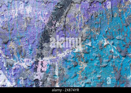 Purple, blue and dark gray color splattered cement wall, great texture for background. Stock Photo