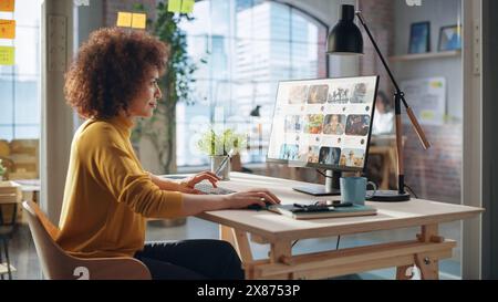 Middle Eastern Female Working in Creative Agency, Looking Through Social Media Trends for Marketing. Successful Specialist Using Computer with Video Streaming Platform Display Stock Photo