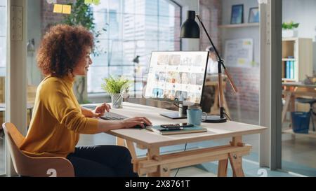 Middle Eastern Female Working in Creative Agency, Looking Through Social Media Trends for Marketing. Successful Specialist Using Computer with Video Streaming Platform Display Stock Photo