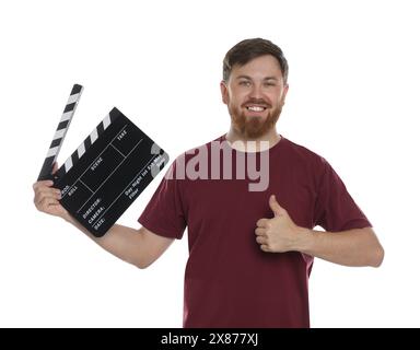 Making movie. Smiling man with clapperboard showing thumb up on white background Stock Photo