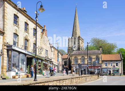 Pickering sops on the Market Place and Birdgate with the tower of St Peter and St Paul's Church Pickering North Yorkshire England UK GB Europe Stock Photo