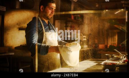 In Restaurant Professional Chef Preparing Pizza, Tenderly Working, Kneading Dough, Traditional Family Recipe. Authentic Pizzeria with Deliciously Organic Food. Cinematic Sunny Shot Stock Photo