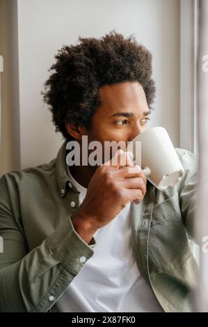 Man drinking from coffee cup at home Stock Photo