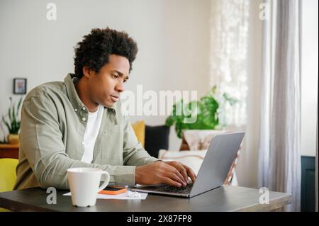 Businessman using laptop typing at table working from home Stock Photo