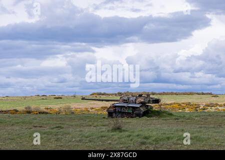 Ruins of a rusting abandoned tank near Imber village on MOD military training ground, Salisbury Plain, Wiltshire, England, UK Stock Photo