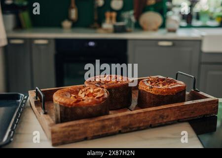 Freshly baked Easter cake on wooden tray in kitchen Stock Photo