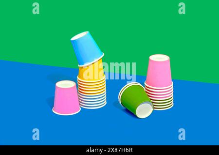Colorful still life of disposable paper cups on two tone colored background Stock Photo