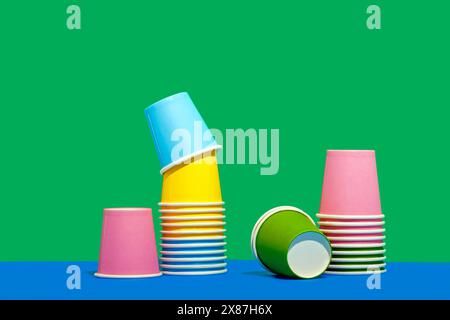 Colorful paper cups against two tone colored background Stock Photo