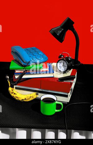 Still life of vintage style home office setup with coffee and banana on table Stock Photo