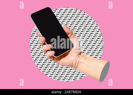 Hand of woman holding blank screen smart phone against colored background Stock Photo