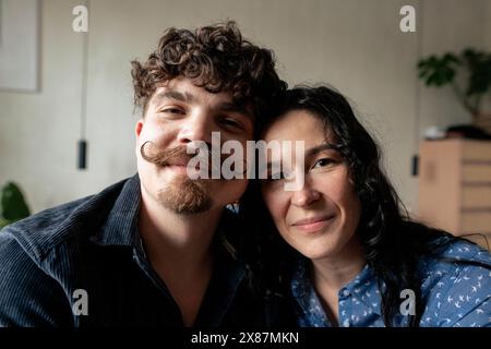 Smiling boyfriend and girlfriend at home Stock Photo